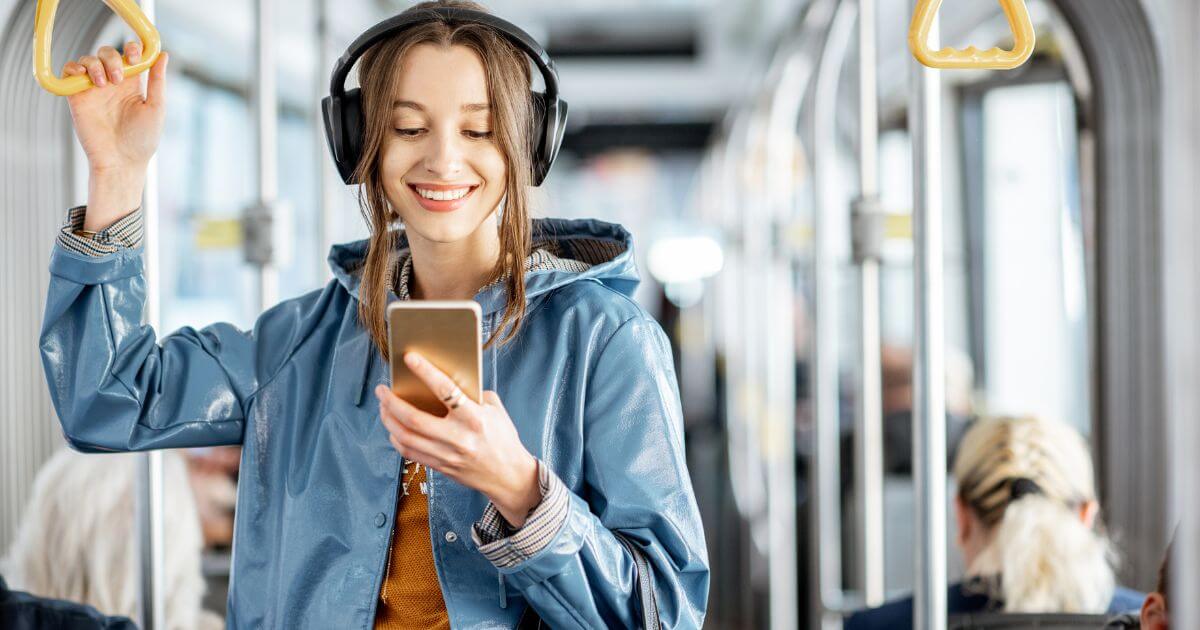 Passenger using UrbanThings mobile app on a bus