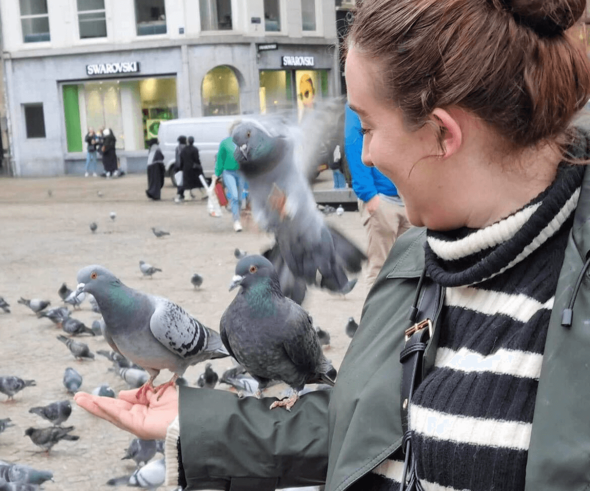 Nicole, Business Development Manager, holding a pigeon